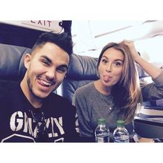 a man and woman sitting next to each other on an airplane