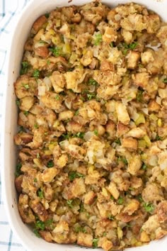 a casserole dish with stuffing in it on a blue and white checkered cloth