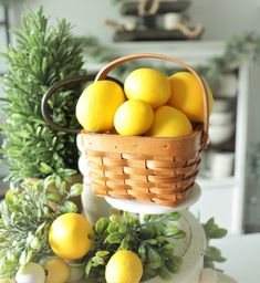 a basket filled with lemons sitting on top of a table