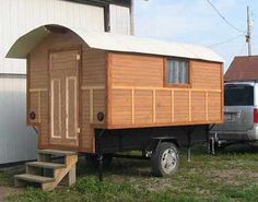 a tiny house sitting on the back of a truck