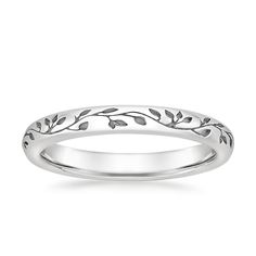 a white gold wedding ring with leaves on it