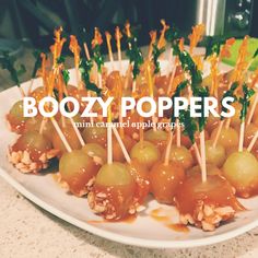 small appetizers with toothpicks are arranged on a white plate and the words boozy poppers above them