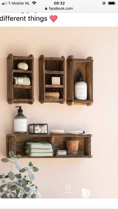 two wooden shelves with soaps, shampoo and other items on them against a pink wall