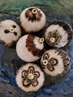 four mushrooms with brown and white designs on them