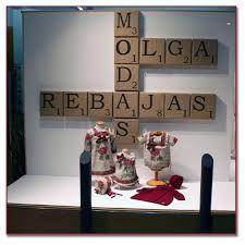 a display case with clothes and letters on the wall in front of it that says mogula rebajaas