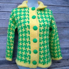 "Vintage original yellow and green wool cardigan sweater with covered metal buttons.  I am guessing on the age of this, could be 1960s or 1970s, it appears to be handmade as there are no labels.  The colors are bright and it is thick and fluffy. It looks/feels like it is at least partially mohair or angora. It has long, lustrous fibers and it is very, very soft. Sweater doesn't have any obvious wear or damage, taking a whiff up close, it smells a little like \"older estate\", ie no particular or Yellow Knitted Retro Sweater, Vintage Green Cardigan With Button Closure, Green Vintage Cardigan With Buttons, Retro Wool Cardigan With Buttons, Yellow Buttoned Sweater For Fall, Yellow Sweater With Button Closure For Winter, Fall Yellow Sweater With Buttons, Bad Smell, Soft Sweater