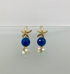 ✔️Handmade earrings with a marine style! Made with gold-plated 925 silver hooks depicting starfish. Pearl pendants in blue agate and cluster of aquamarine and freshwater pearls. Buy this versatile accessory and give a gift to yourself or to an important person! ✔️DETAILS: 🟩 Materials: 925 silver Gold Agate Aquamarine River pearls 🟧🟧Dimensions: Earring Length: Approx. 5cm/2" Blue pearl size: 14 cm/ 5.6"  Nickel and lead free 🔔 Artisan Jewelry My jewels are strictly handmade so each of them is Elegant Handmade Starfish Earrings, Elegant Starfish Charm Earrings As Gift, Elegant Starfish Charm Earrings For Gift, Elegant Blue Jewelry With Starfish Charm, Elegant Blue Starfish Charm Jewelry, Blue Starfish Charm Earrings For Gift, River Pearls, Stella Marina, Earrings Star