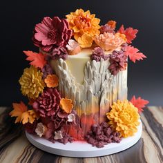 a cake decorated with flowers on top of a wooden table