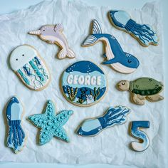 decorated cookies are arranged in the shape of sea animals