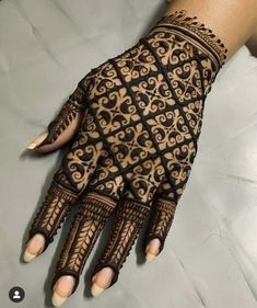 a woman's hand is decorated with hennap and intricate designs on it