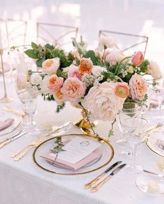 an elegant table setting with pink and white flowers