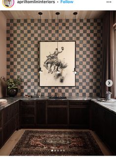 a kitchen with checkered walls and wooden cabinets