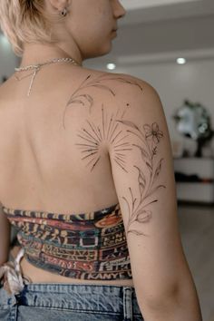 a woman with a flower tattoo on her back