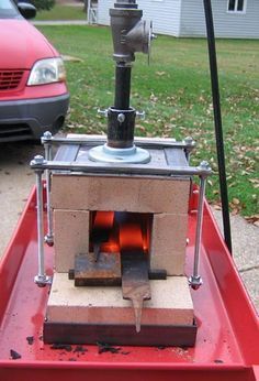 a red cart with an open fire pit in it