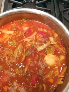 a pot filled with soup sitting on top of a stove