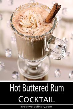 hot buttered rum cocktail in a glass mug with cinnamon garnish on top