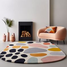 a living room with a colorful rug, chair and fire place in the corner on the floor