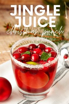 a christmas punch with cranberries and mint garnish