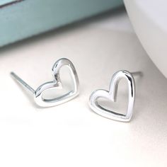 A stunning pair of irregular shaped open heart stud earrings made from sterling silver with a beautiful polished finish These silver heart stud earrings feature a classic butterfly and post fastening and are suitable for almost any age. A lovely Christmas gift, stocking filler or for a birthday treat for someone you love. Versatile and easy-to-wear, our stunning earrings shine when worn on their own or will add some sparkle to your stacked earring look in a second or third piercing. A wonderfull Silver Open Heart Minimalist Earrings, Silver Minimalist Open Heart Earrings, Personalized Silver Heart Earrings, Sterling Silver Open Heart Earrings For Gift, Heart Shaped Frame, Silver Heart Earrings, Stacked Earrings, Silver Jewelry Earrings, Opal Earrings Stud