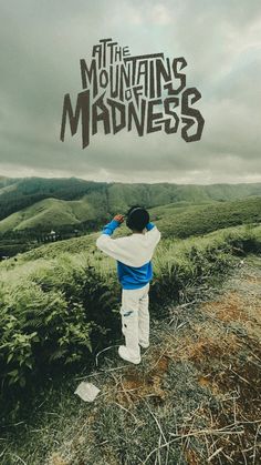 a man standing on top of a lush green hillside under a cloudy sky with the words, the mountains of mardyness