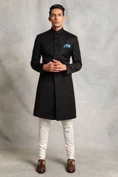 Black sherwani with mandarin collar, front and cuff button placket. Paired with kurta and churidar.
Component: 3
Pattern: Plain
Neckline: Mandarin
Sleeve Type: Full Sleeves
Fabric: Poly Viscose, Cotton Silk
Color: Black
Other Details: 
Front and cuff button placket
Note: Pocket square worn by the model is not for sale
Occasion: Wedding - Aza Fashions Plain Sherwani, Black Sherwani, Sherwani For Men Wedding, Sherwani For Men, White Pajamas, Wedding Sherwani, Indian Fashion Designers, Sherwani, Churidar