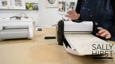 a person standing in front of a sewing machine with the words sally lurst on it