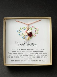 a necklace in a box with a poem on it that says, soul sister one in a while someone comes into the world