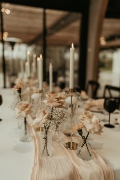 the table is set with candles and flowers