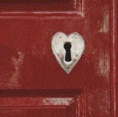 a red door with a heart shaped keyhole