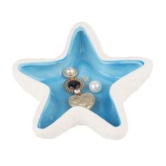 a blue and white star shaped dish with pearls