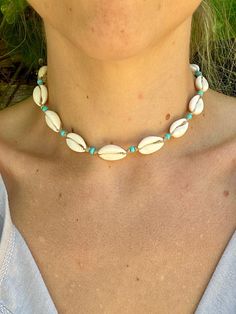 Hand made genuine cowrie shell choker necklace with aqua blue glass beads, knotted organic hemp and a coconut shell button. This necklace is metal free. It measures 16 inches from end to end. Please measure your neck or favorite necklace to make sure you get a good fit! If you are interested in a custom size, send me a message!  Each necklace is made to order and will ship 1-2 days from when you place your order.  These are also hand made with real natural shells and glass beads and may vary slightly from the picture due to Mother Nature making every shell unique :) Handmade Ocean-inspired Beaded Necklaces For Vacation, Bohemian Shell Jewelry For Beach, Bohemian Shell Jewelry For Beach Season, Bohemian Turquoise Choker For Summer, Beaded Shell-shaped Beachy Jewelry, Beaded Shell-shaped Jewelry For The Beach, Beachy Beaded Shell-shaped Jewelry, Shell-shaped Beaded Jewelry For Beach Season, Handmade Turquoise Jewelry For Beach Season