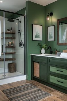 a bathroom with green walls and wooden floors