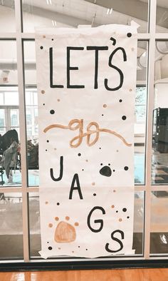 a sign that says let's go jags in front of a glass door