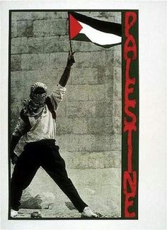 a man holding a red and black flag in front of a brick wall with the word protest written on it