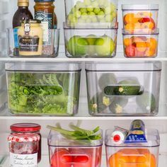 an open refrigerator filled with lots of different types of vegetables and fruit in plastic containers