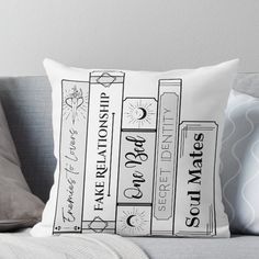 a black and white pillow with books on it