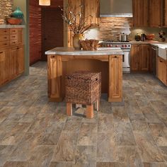 a kitchen with wood cabinets and tile flooring