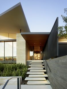 the stairs lead up to this modern house