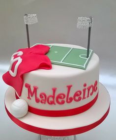 a cake that is decorated to look like a tennis court and the name madelieine on it