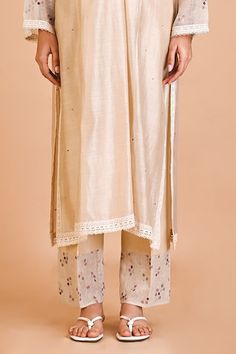 Ivory silk chanderi tunic with floral embroidery. Comes with pant and an inner. - Aza Fashions Festive Off-white Palazzo Set With Embroidered Border, Spring Raw Silk Palazzo Set With Straight Kurta, Spring Palazzo Set In Raw Silk With Straight Kurta, Spring Palazzo Set With Straight Kurta In Raw Silk, Raw Silk Palazzo Set With Straight Kurta For Spring, Cream Palazzo Set With Embroidered Border For Diwali, Cream Embroidered Palazzo Set For Eid, Festive Cream Palazzo Set With Embroidered Border, Off White Silk Straight Kurta Set