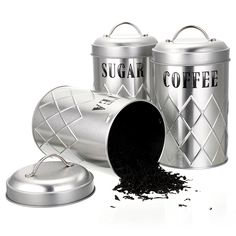 three metal canisters filled with black tea