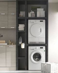 a washer and dryer in a room with cabinets