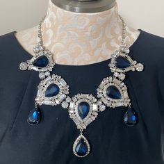 New With Tag! Simply Stunning Statement Necklace! Silver Tone With Deep Blue & Clear Rhinestone Accents. The Center Piece Including Dangle Is Approx 3.5” Long Chain Has 3” Extender To Adjust Length Of Necklace Blue Stone Necklace For Formal Occasions, Formal Blue Necklace With Stones, Formal Blue Necklaces With Stones, Blue Crystal Rhinestone Costume Necklace, Formal Blue Stone Necklace, Sapphire Crystal Necklace With Sparkling Stones, Blue Rhinestone Necklaces For Evening, Elegant Blue Rhinestone Necklace With Sparkling Stones, Blue Rhinestone Necklace For Evening