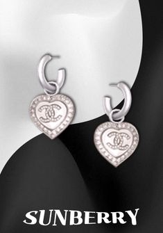 pair of heart shaped earrings with cz diamonds on the front and back of each ear