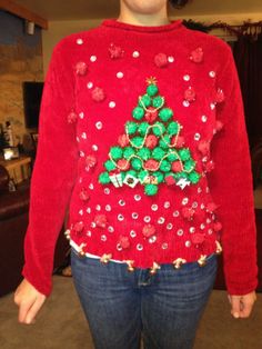 a woman wearing a red sweater with a christmas tree on it