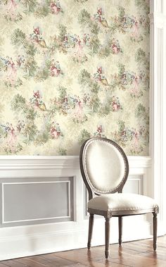 a white chair sitting in front of a wallpapered room with flowers on it