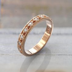 a gold ring with small diamonds on it