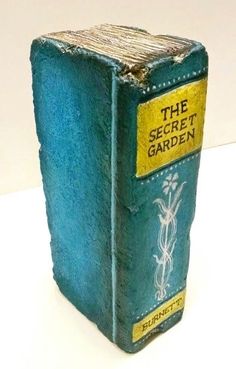 an old blue book with the words the secret garden written on it's cover