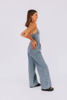 Get ready to turn heads in our Fair Share Jumpsuit! With a sweetheart neckline and adjustable spaghetti straps, this button-up denim jumpsuit is both stylish and practical. The wide leg and side zipper make it easy to wear, while the pockets keep your essentials close at hand. Make a statement with this must-have piece! Details Sweetheart neckline Button-up Wide leg Denim Adjustable spaghetti straps Side zipper Pockets Sizing Approximate measurements: SIZE LENGTH/INSEAM BUST Small 53/32" 34" Med Spring Jeans With Adjustable Straps, Denim Blue Jumpsuit With Adjustable Straps, Casual High Rise Strapless Denim Jumpsuit, Spring Denim Jumpsuits And Rompers With Adjustable Straps, Spring Medium Wash Jumpsuits And Rompers With Adjustable Straps, Summer Full Length Denim Jumpsuits And Rompers, Trendy Denim Jumpsuits And Rompers With Adjustable Straps, Full Length Denim Jumpsuits And Rompers For Summer, Spring High Rise Strapless Denim Jumpsuit