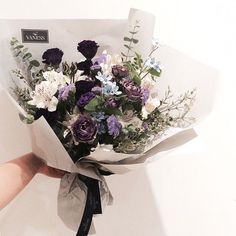 a person holding a bouquet of flowers in their hand